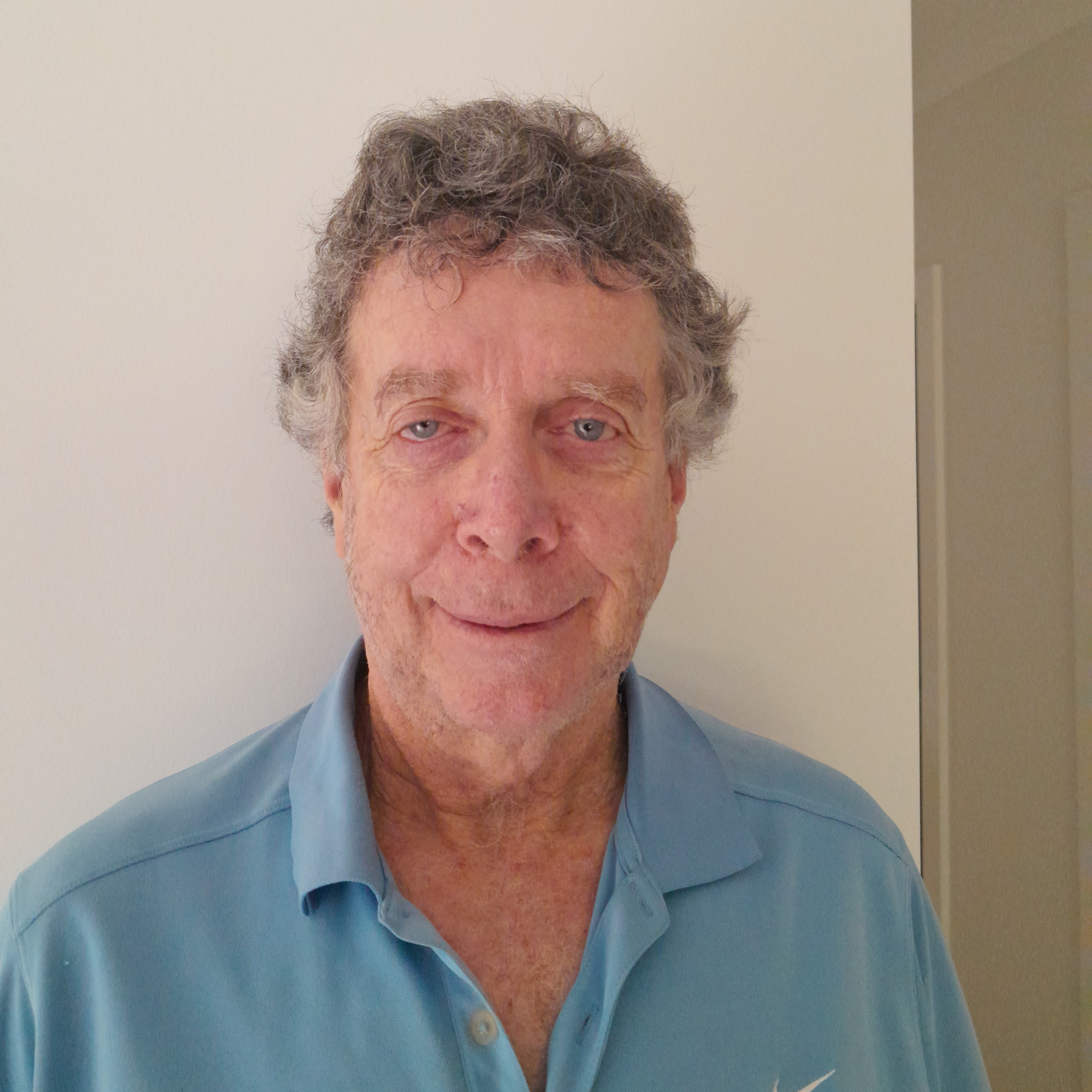 Casual portait image of Dr Robert Whannell in front of a plain background. 